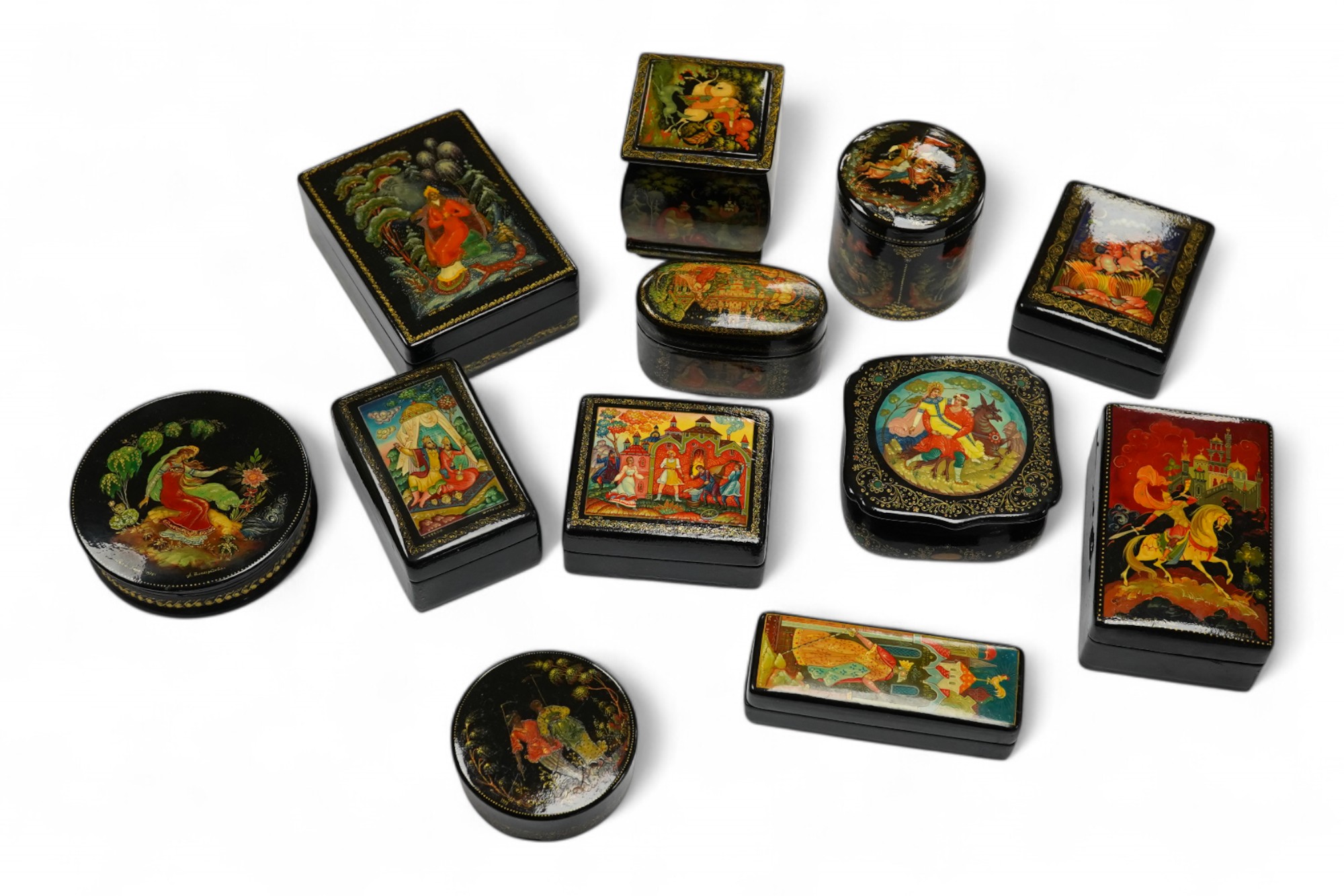 A quantity of Russian lacquer boxes decorated with figures and mythical scenes, largest 10cm in length. Condition - mostly good